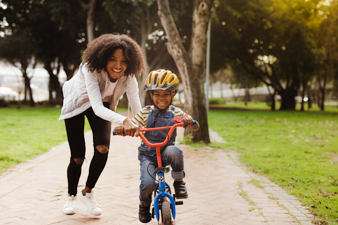 Mother teaching son to ride bike