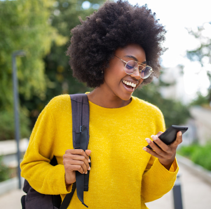 Smiling young black woman wearing prescription sunglasses