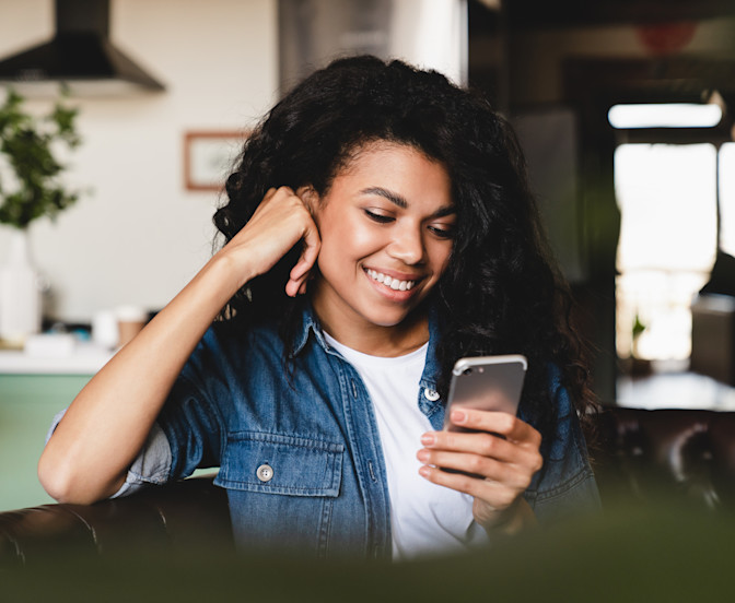 Girl Smiling Looking at her Phone