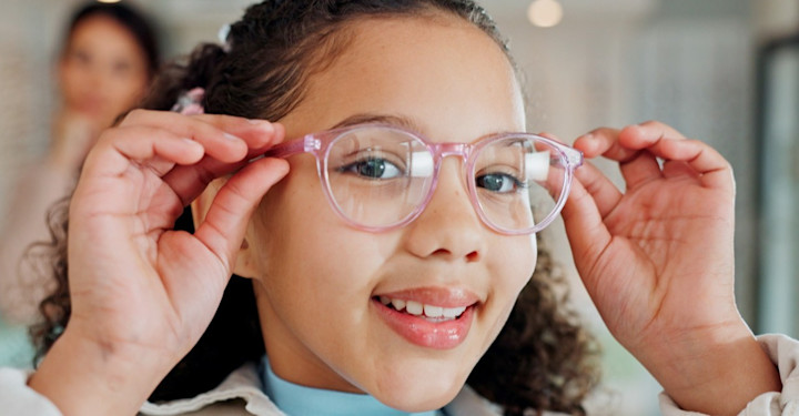 Girl smiling wearing pink glasses