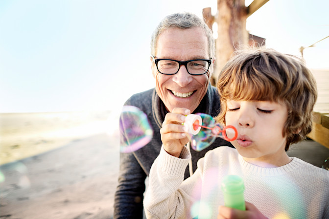 Happy older glaucoma patient with grandson smiling